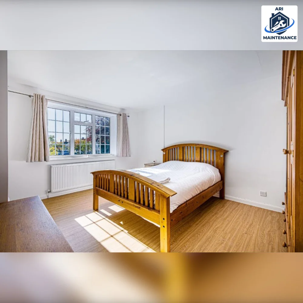 Painting and decorating: bedroom finished in white emulsion with white gloss skirting and window reveal, leaded casement window and oak-effect floor