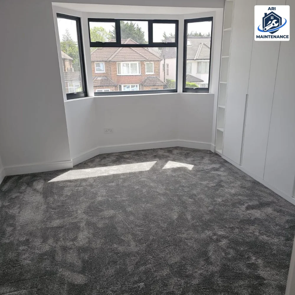 Bedroom, grey carpet, white walls, bay window