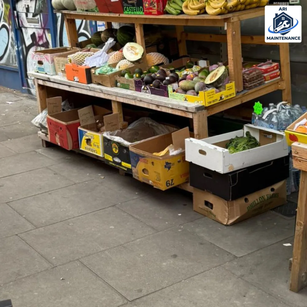 Handyman carpentry: two-tier timber produce display stand built for a London greengrocer, stacked with fruit and vegetable crates